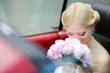 Beautiful young bride portrait in a car