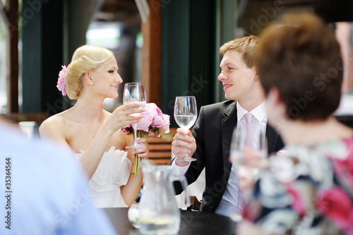 Photo: Bride and groom drinking champagne at their wedding Bride and groom drinking champagne at their wedding
