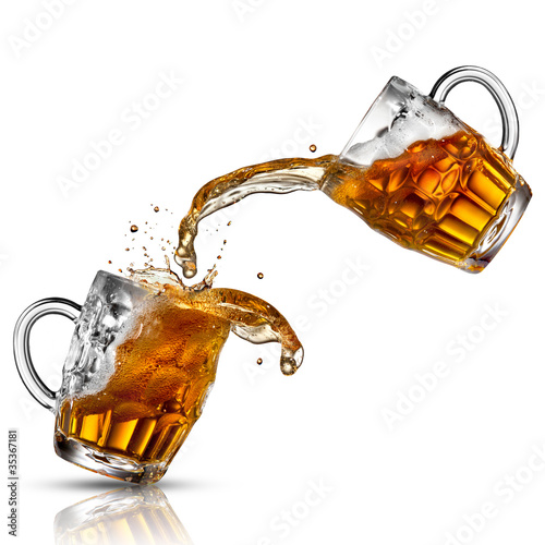 Photo: Beer splash in glasses isolated on white Beer splash in glasses isolated on white