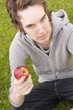 Young man holding an apple Young man holding an apple