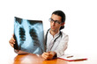Male doctor looking at x-ray image