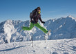 woman in ski cloths jumping over the snowy mountains, austria