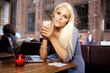Young woman with laptop on cafe