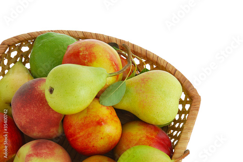 Photo: Cropped closeup of decorative interwoven basket with fresh frui Cropped closeup of decorative interwoven basket with fresh frui
