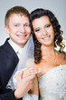 Just married groom and bride on gray