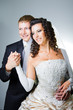 Just married groom and bride on gray