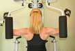 Fit blond woman uses exercise machine