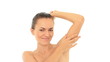 Young woman stroking her clean armpit, isolated on white