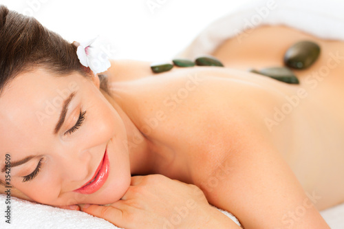 Photo: Beautiful woman getting hot stone massage Beautiful woman getting hot stone massage