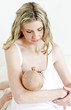 portrait of mother nursing her baby