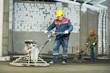 Worker trowelling and finishing of concrete Worker trowelling and finishing of concrete
