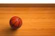 A basketball on wooden floor as background