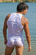 Sexy muscle young boy standing in water