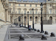 A row of lamps along a path in a courtyard in Paris, France.