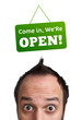 Young persons head looking at closed and open signs Young persons head looking at closed and open signs