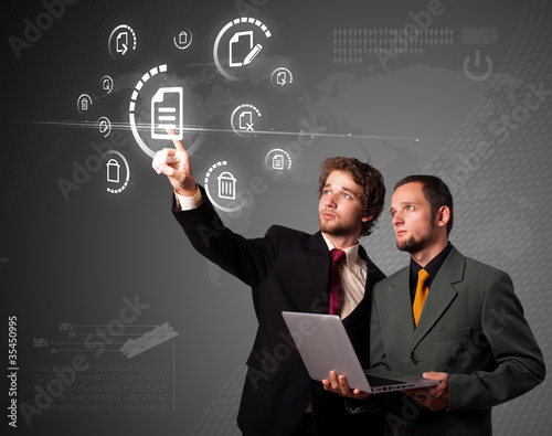 Foto: Businessman pressing modern business type of buttons Businessman pressing modern business type of buttons