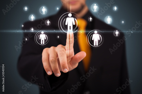 Photo: Businessman pressing modern social type of icons Businessman pressing modern social type of icons