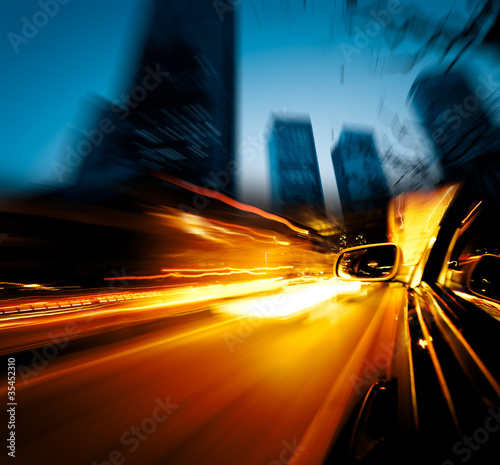 Photo: speeding car through city speeding car through city