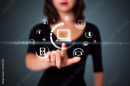 Photo: Businesswoman pressing virtual media type of buttons Businesswoman pressing virtual media type of buttons
