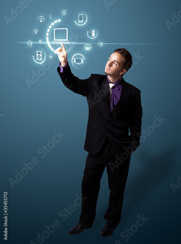 Photo: Businessman pressing virtual media type of buttons Businessman pressing virtual media type of buttons