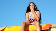 Girl Eating Blueberries On The Beach