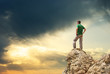 Man on peak of mountain.