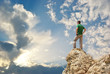 Man on peak of mountain.
