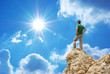 Man on peak of mountain.