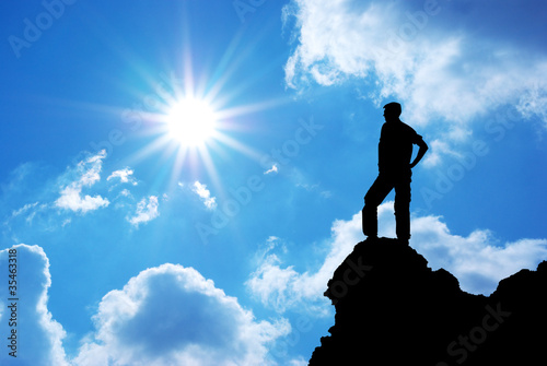 Photo: Man on peak of mountain. Man on peak of mountain.