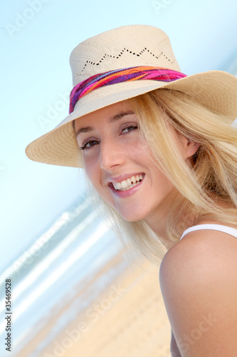 Photo: Portrait of beautiful woman at the beach Portrait of beautiful woman at the beach