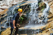 Men descending waterfall