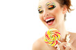 woman laughing with candy and beautiful make-up young attractive woman laughing with candy and beautiful make-up young attractive