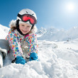 Ski, snow and fun - happy skier playing in snow