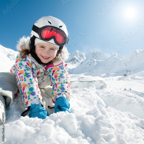Photo: Ski, snow and fun - happy skier playing in snow Ski, snow and fun - happy skier playing in snow