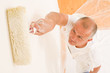 Home decorating mature man painting wall roller