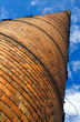 Huge brick chimney under blue sky