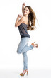 Happy girl in jeans posing at studio