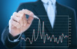businessman writing graph of stock market businessman writing graph of stock market