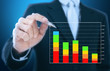 businessman writing graph of stock market