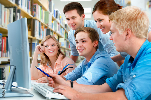 Photo: group of students in a college library group of students in a college library