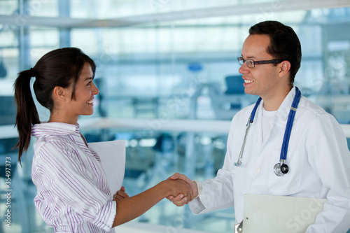 Photo: Insurance agent with a doctor handshaking Insurance agent with a doctor handshaking