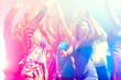 Party people dancing in disco or club