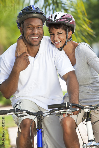 Photo: Happy African Man & Woman Couple Riding Bike Smiling Happy African Man & Woman Couple Riding Bike Smiling