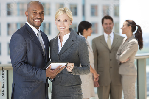 Photo: Interracial Men & Women Business Team With Tablet Computer Interracial Men & Women Business Team With Tablet Computer