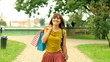 Woman with shopping bags walking in the city, steadycam shot