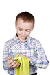 The boy wipes the glass with a napkin.