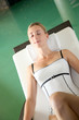 Beautiful woman relaxing in longchair by pool