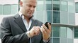 Video: man near office building sending email with cell phone man near office building sending email with cell phone