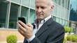 Video: man smiling near office building with cell phone man smiling near office building with cell phone