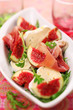 Fresh salad with figs, prosciutto and goat cheese, soft focus Fresh salad with figs, prosciutto and goat cheese, soft focus